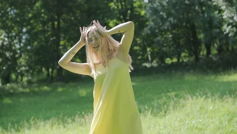 woman in yellow dress dancing gracefully in summer park