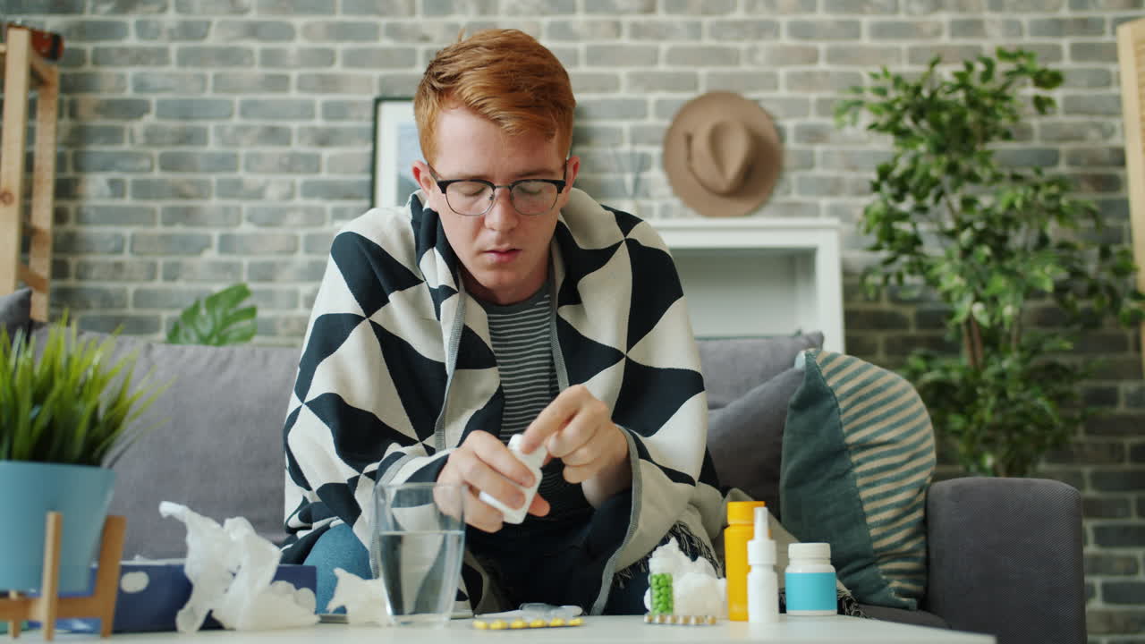 Sick Man Taking Medication at Home