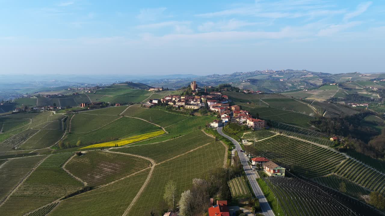 Serralunga d'Alba, iconic hilltop village and castle,Langhe vineyards, Piedmont, wine region, Italy. Aerial forward, copy space