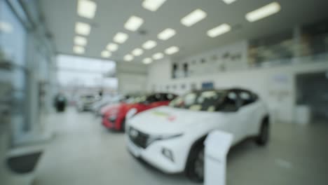 blurred background. car showroom for new prestigious cars. a large assortment of new cars in the showroom