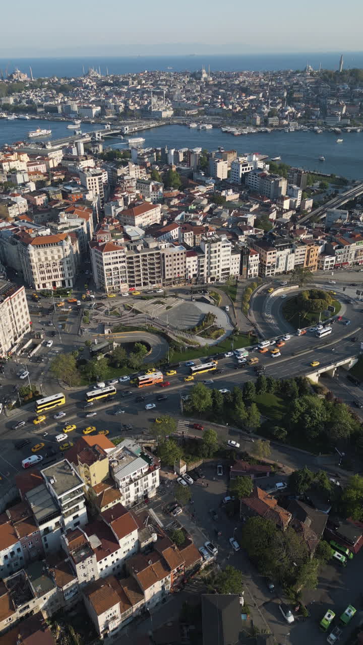 Vertical drone shot overlooking traffic in Istanbul city, golden hour in Turkey