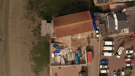 aerial view of a coastal town with boathouse and boats