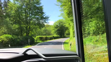 Aus-Der-Sicht-Der-Passagiere,-Die-In-Einem-Bus-Sitzen-Und-Durch-Einen-Grünen-Wald-In-Luxemburg-Fahren