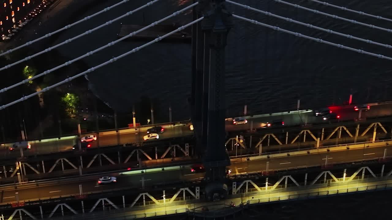 View of cars crossing Manhattan Bridge at night in New York City