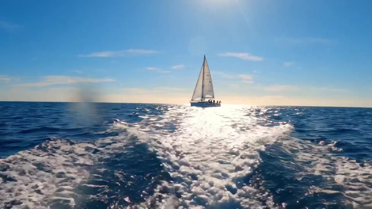 A Serene Sailing Journey Across the Sparkling Ocean Under a Clear Blue Sky: Embracing the Beauty of Adventure and Tranquility at Sea