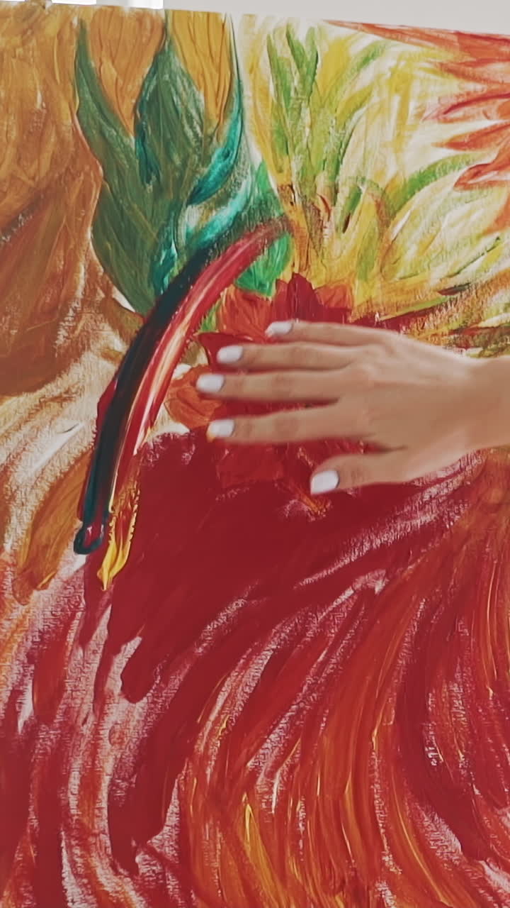 Skilled woman artist in white shirt draws bight red exotic flower touching canvas fixed on easel by fingers in studio slow motion close backside view