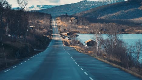 A-narrow-rural-road-winds-through-the-arctic-plateau