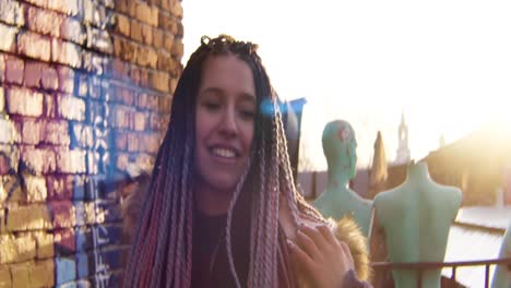 young woman with braids on a rooftop