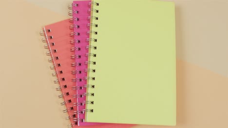 Three-notebooks-with-binding-and-copy-space-on-orange-background