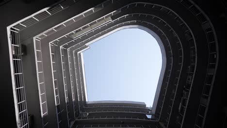 perspective bottom view of semicircular construction of minimalist urban design architecture futuristic background. spiraling structure. swirling up to sky. architecture urban minimalist background