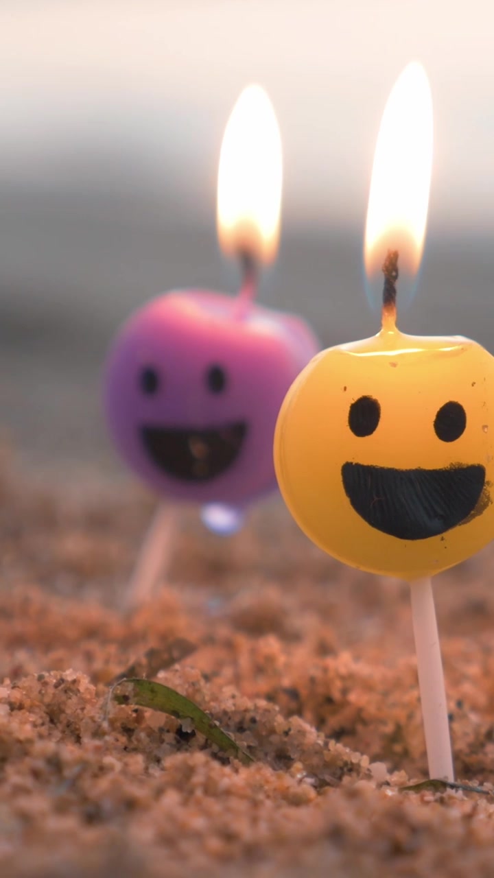 Smiley candles on the beach