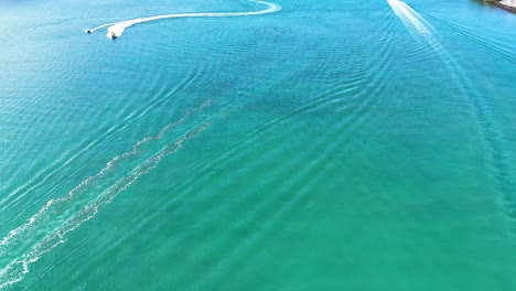 boats creating patterns on tweed river surface