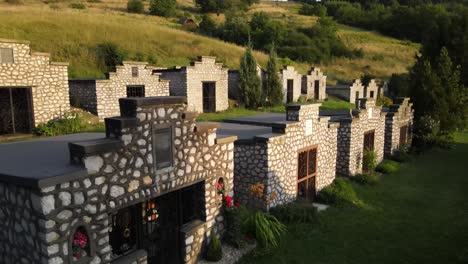 two rows of small, stone mausoleums in varbo, hungary cemetery