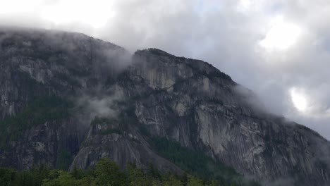 clouds capping granite dome the chief - stawamus chief mountain in british columbia, canada