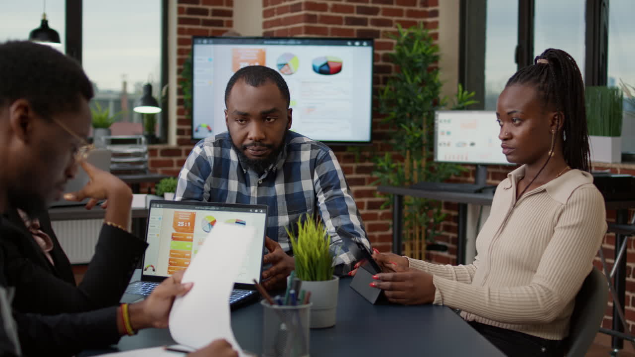 African american team of workers doing teamwork on financial project