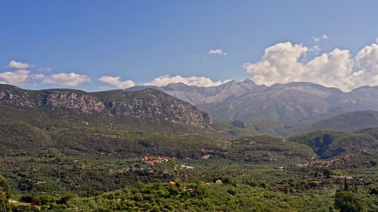 Drone flies over rural Peloponnese olive tree mountain landscape