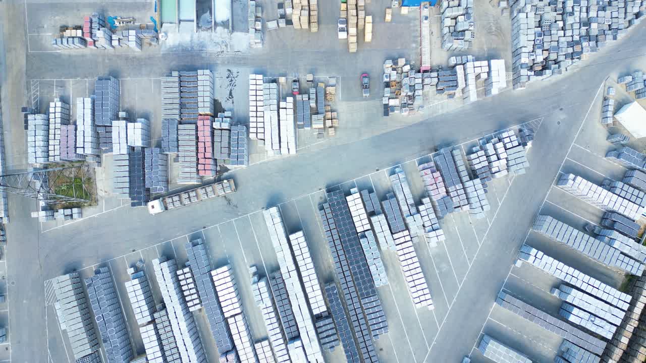 conductor de carretilla elevadora en almacén conduciendo entre filas de estanterías con pilas de cajas y materiales de embalaje