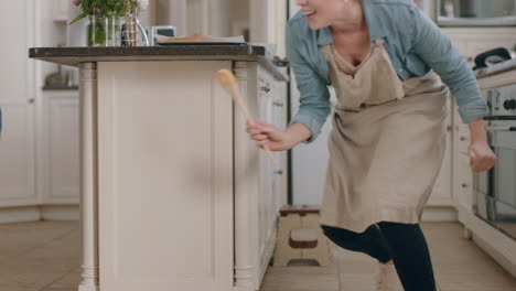 happy mother and son playing in kitchen mom chasing little boy running enjoying fun game at home