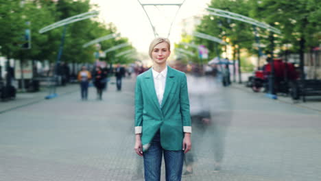 woman in teal blazer on a busy city street