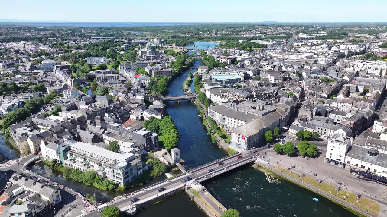 Aerial high rise over river Corrib in Galway city, Ireland. Sunny day, cityscape. Urban