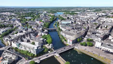 aerial high rise over river corrib in galway city, ireland. sunny day, cityscape. urban