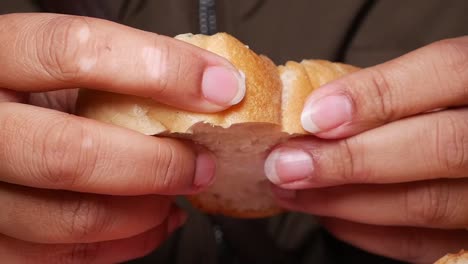 hands breaking a piece of fresh bread
