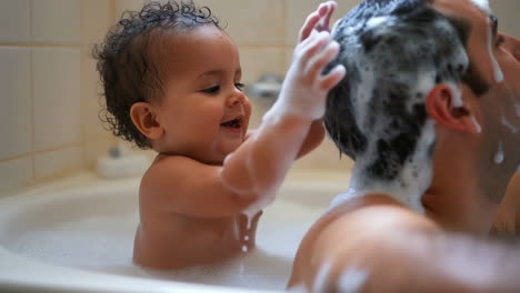 baby and father enjoying bathtime together