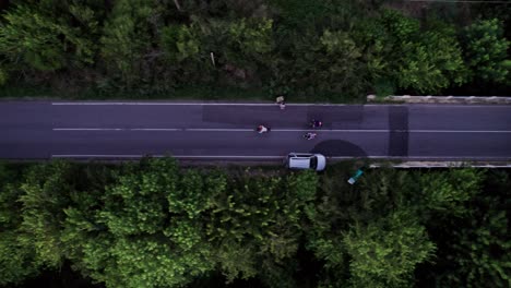 top view aerial tracking of three cyclists in a road, ignacio correa, buenos aires