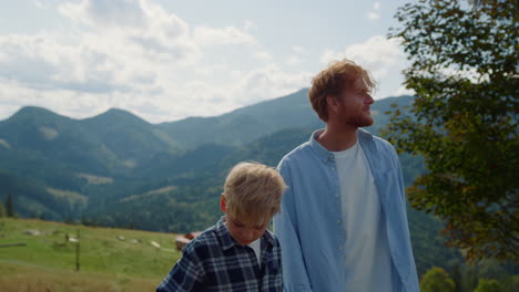 father son active leisure on green hill closeup. man walking boy on nature.