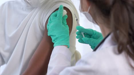 young man visits skillful doctor at hospital for vaccination