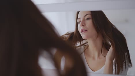woman looking at herself in the mirror