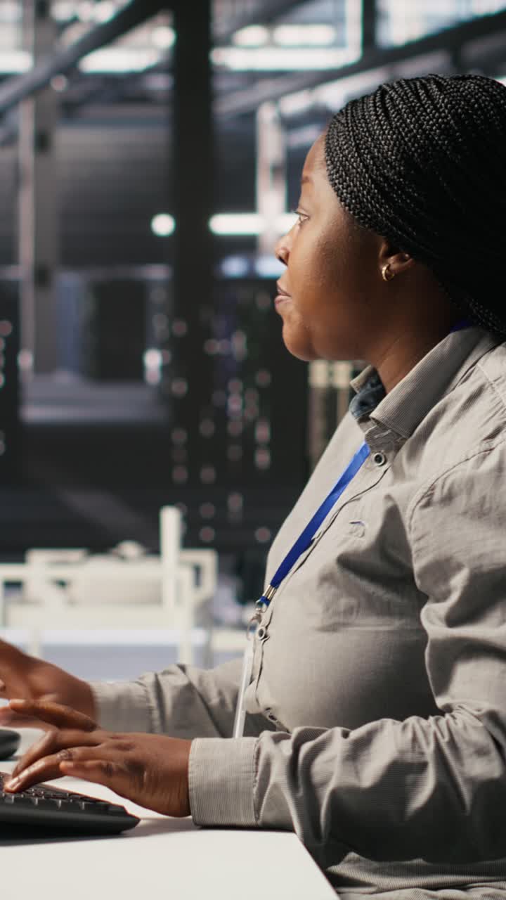 Vertical video Scared data center technicians reacting to virus warning on PC display, running