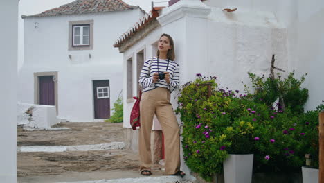 Tourist-admiring-city-architecture-on-vacation-vertical.-Pretty-girl-pose-street