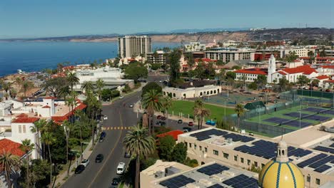 aerial flight over a yellow domed tower towards tennis courts in la jolla california