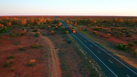 Slow-Aerial-View-of-a-Land-Train-passing-on-Stuart-Highway---NT---Australia