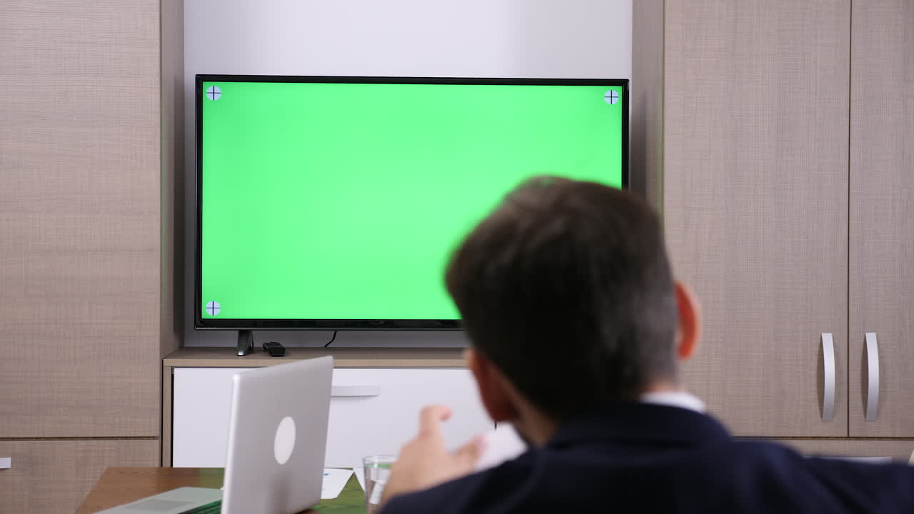 Office scene with green screen television