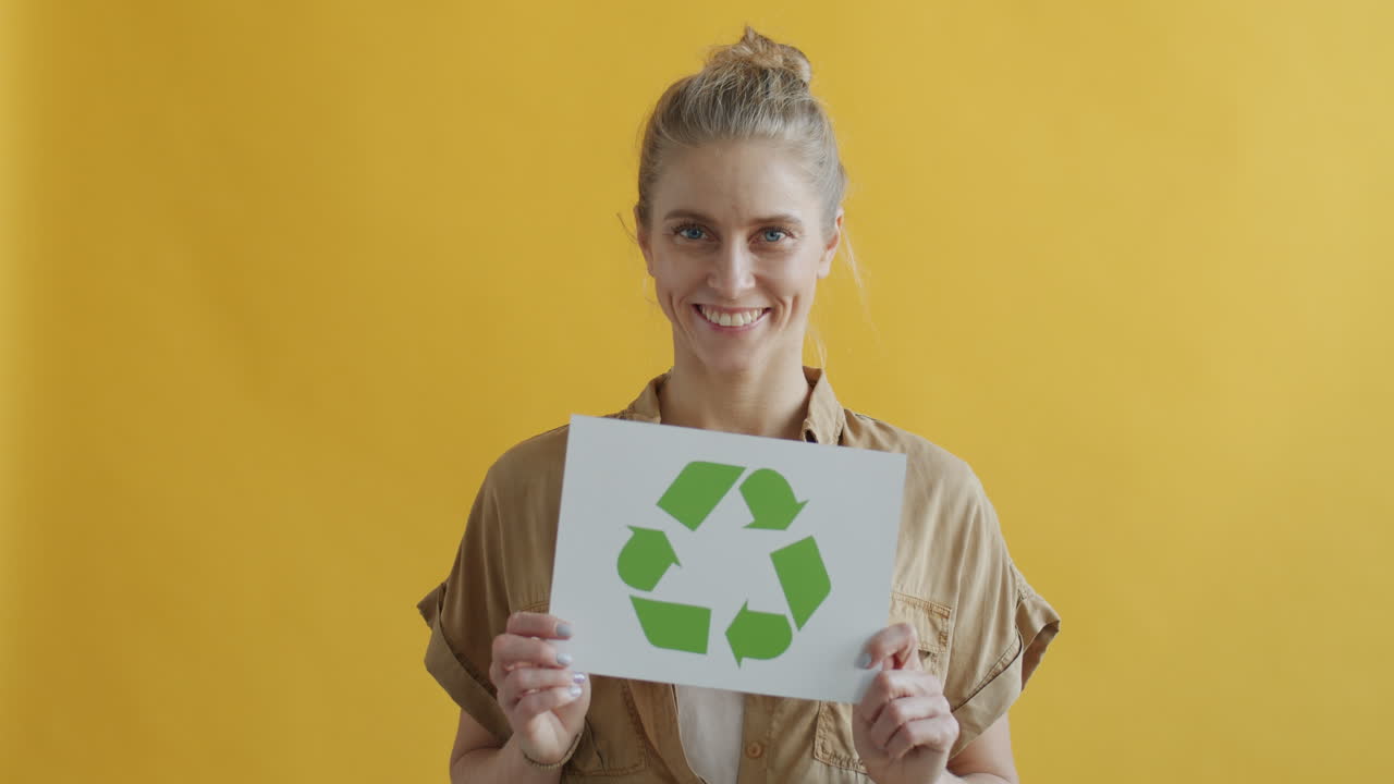 Woman Holding Recycling Sign