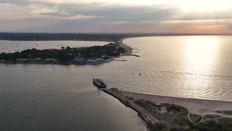 sunrise over sandbanks, poole bay, dorset, uk.