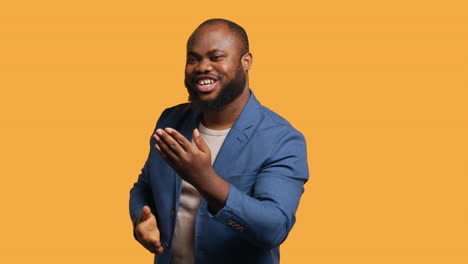 charming person having fun sending air kisses, studio background