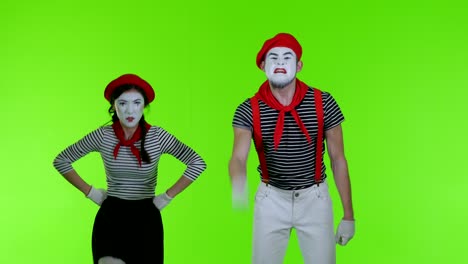 two mime boy and girl get angry against a green background