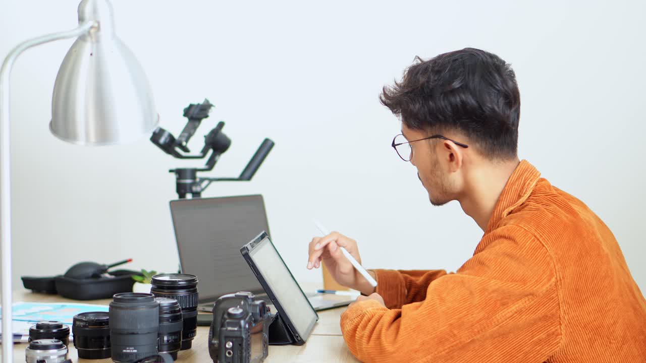 Young Man Using Stylus Pen On Digital Tablet, Working On Photography