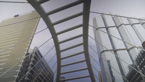 chong nonsi skywalk at sathorn road, business center of bangkok, thailand - stunning scenery of high rise towers under the cloudy sky - panoramic shot