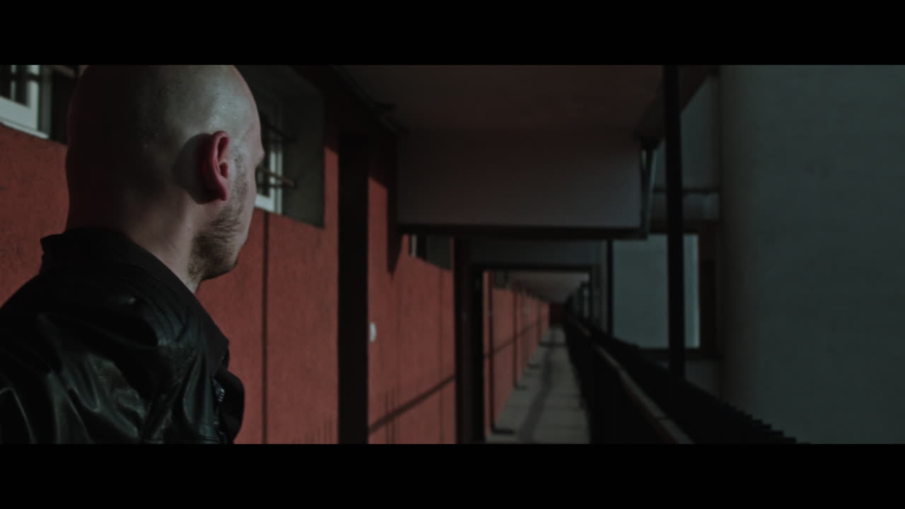 A bald gang member on guard