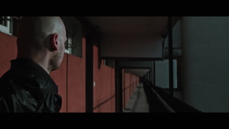 a bald gang member on guard
