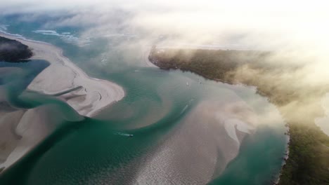 fogs over the noosa river during sunrise in noosa heads, queensland, australia