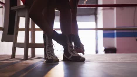 Close-up-view-of-woman-tying-her-shoelaces