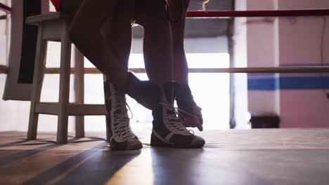 close up view of woman tying her shoelaces
