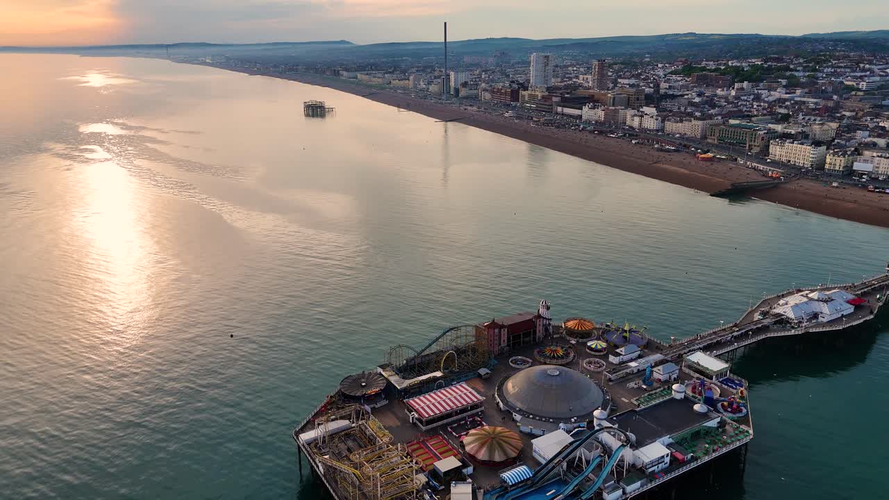 High-resolution aerial shot of Brighton’s iconic seaside pier and busy seafront. Ideal for British travel promos, documentaries, and commercial video use.
