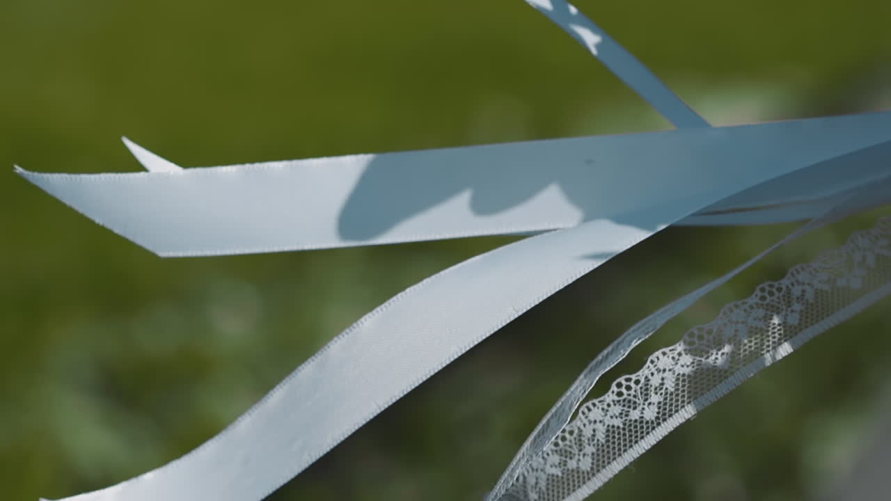 바람에 흔들리는 신부 드레스의 실크 리본과 레이스 스트립