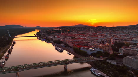 stunning orange sky at sunset over the scenery of the old city. footage above the danube river near the old bridge in bratislava, slovakia